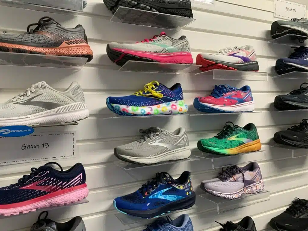 Comparison of Brooks Ghost and Adrenaline running shoes highlighting differences in cushioning and stability features.